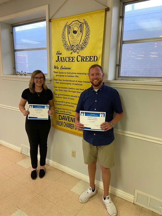 Award winners hold awards in front of Jaycees Creed