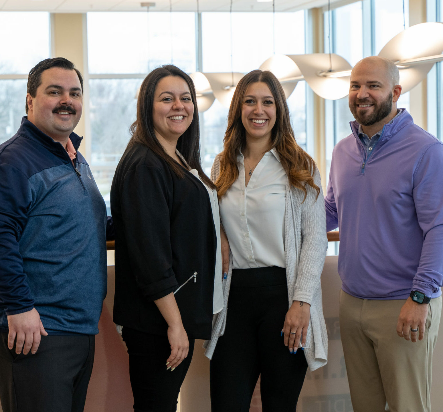 R.I.A. Mortgage Team Group Photo, standing on balcany