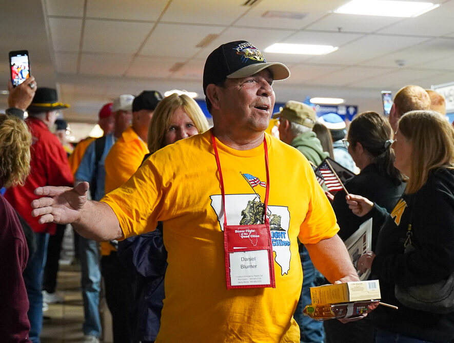 Dan is greeted by a crowd as he exits the Honor Flight flight