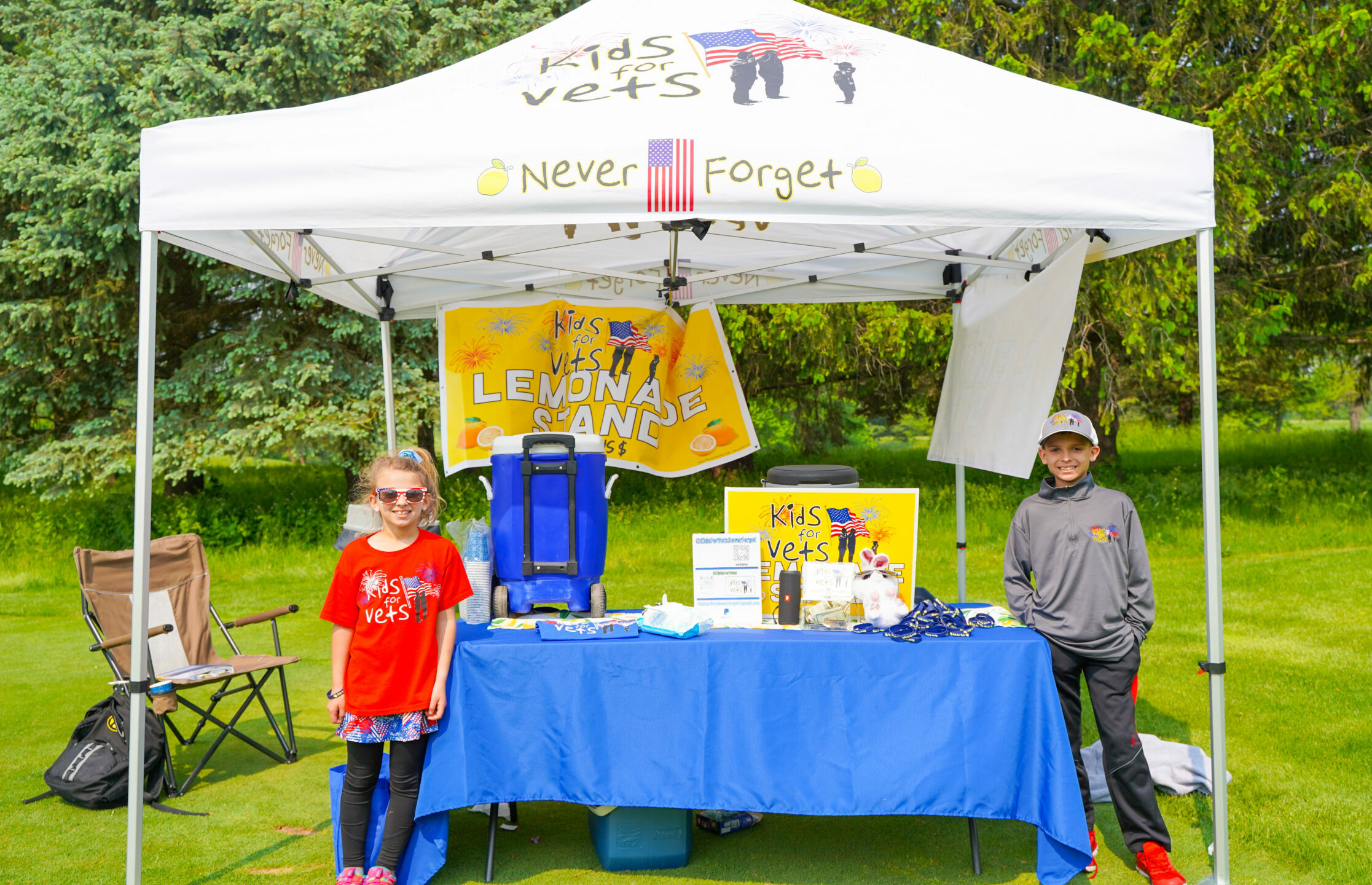Kids stand at their Kids for Vets Lemonade Stand