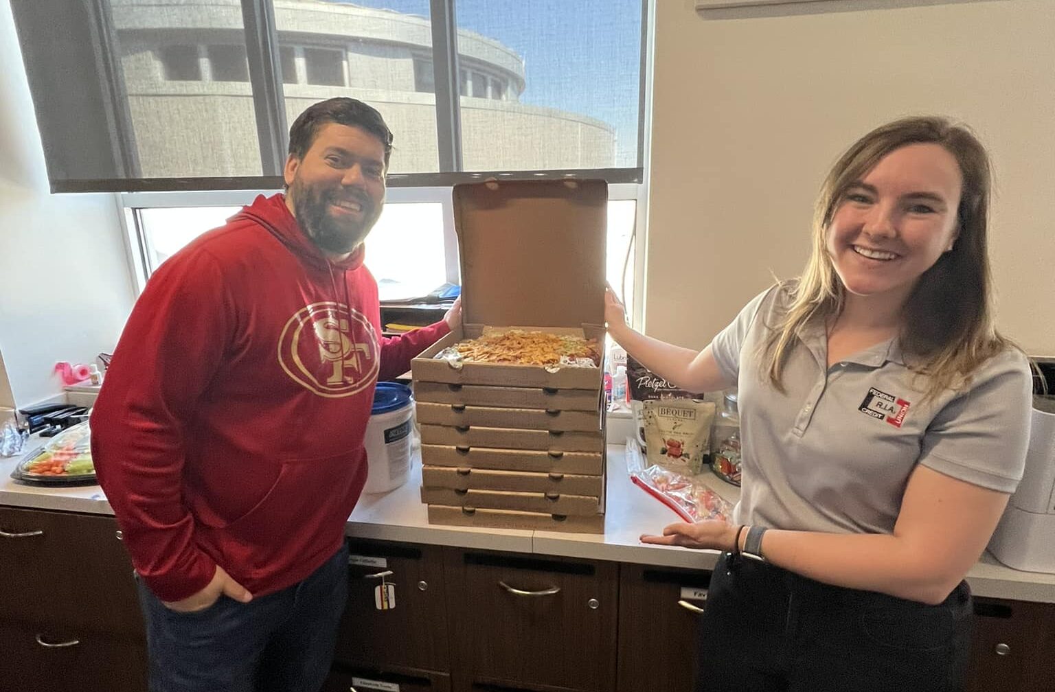 R.I.A. employee giving pizza to telecommunicators